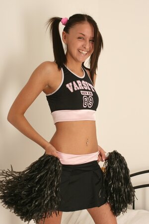 Young pigtailed cheerleader gets naked to pose in white panties