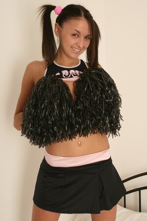 Young pigtailed cheerleader gets naked to pose in white panties