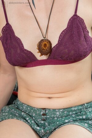 Girl in blue knit socks takes daily clothes off to wear leather bra and panties