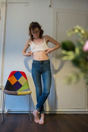 Slender brunette hides her natural bush with cute panties and pulls jeans on