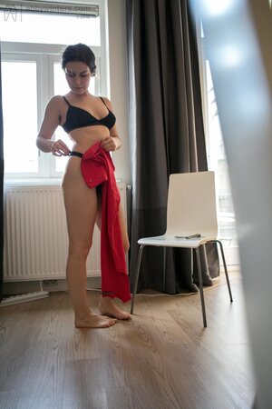 Amateur Daniela covers her natural bush with black panties and puts on red dress