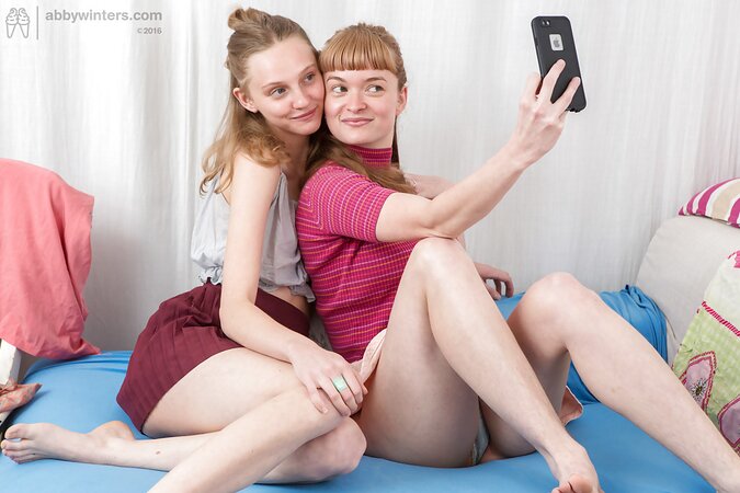 Girls flaunt their hairy snatches to finger and lick them on a small blue bed