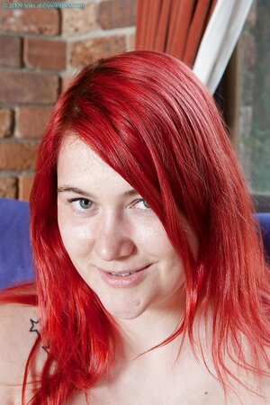 Shy love with dyed red hair isn't sure but still she keeps on stripping