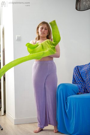 Amateur girl Juliana with big tits puts on her purple pants after showering