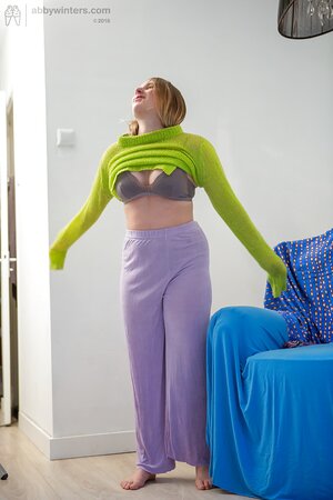 Amateur girl Juliana with big tits puts on her purple pants after showering