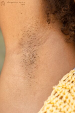Fuzzy-haired black girl puts skateboard down to demonstrate wonderful titties