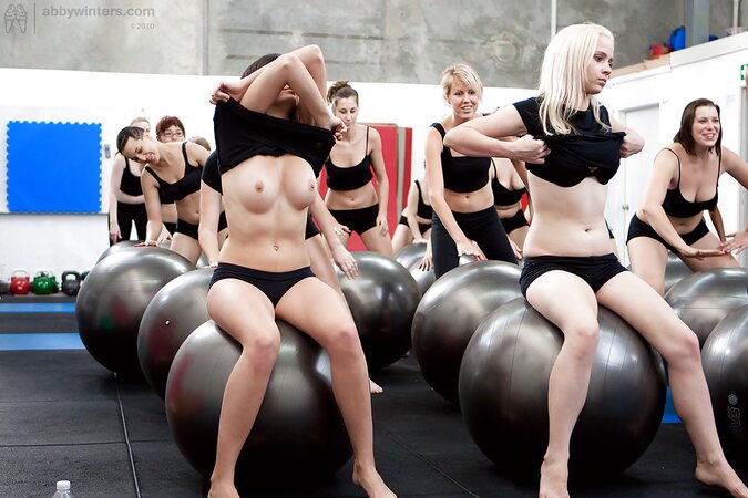 Big group of fitness girls take off their lingerie for the nude workout