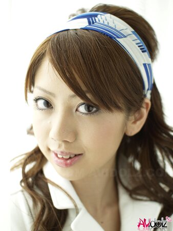 Modest Japanese sweetie dressed in white dress that accentuates her slimness