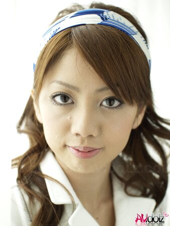 Modest Japanese sweetie dressed in white dress that accentuates her slimness