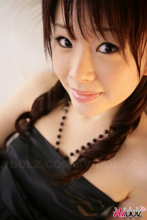 Horny Eastern bitch in a black dress is femme fatale exposing tiny boobs