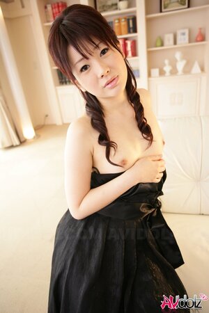 Horny Eastern bitch in a black dress is femme fatale exposing tiny boobs