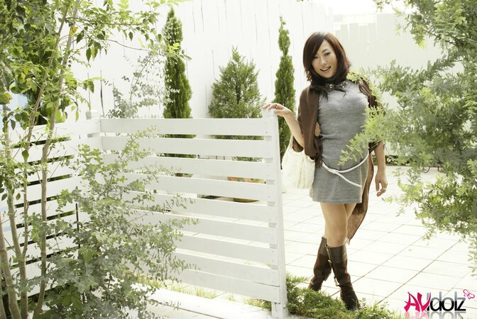 Sexy oriental love in a pretty seductive dress poses outdoors and inside