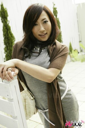 Sexy oriental love in a pretty seductive dress poses outdoors and inside