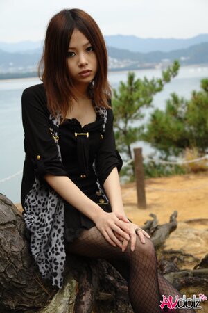 Asian girl with sunglasses on looks so seriously cause she is shy being naked