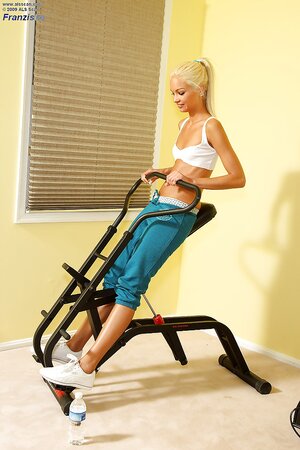 Sportsgirl got hot in a fitness room masturbating with Sybian and a bottle