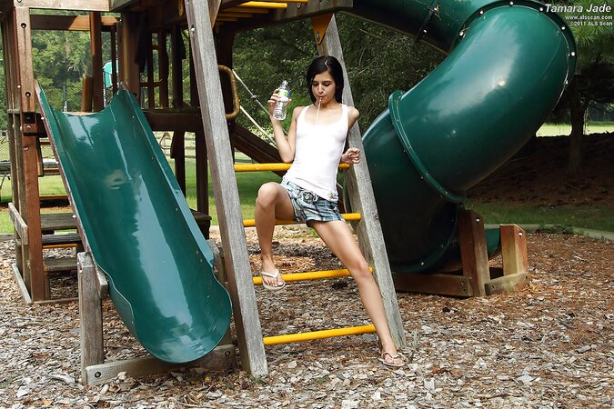 Brunette with pigtails and skinny legs does inappropriate things by green slide