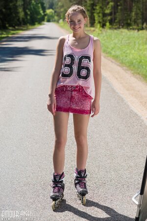 Joyful Russian minx able to peel off clothes while having fun on roller blades