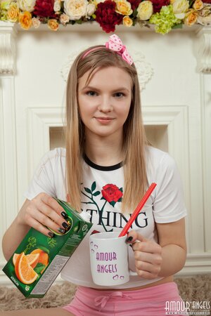 Tasty juice makes cute angel eager to remove all clothes and pose naked