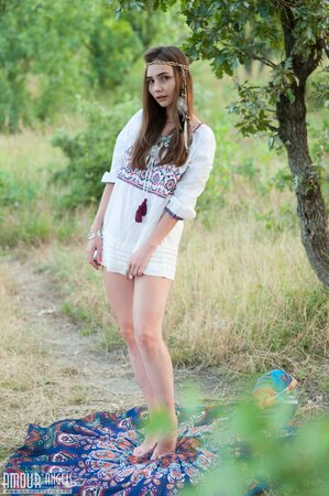 Sweet hippie girl feels unity with nature while relaxing nude in the forest