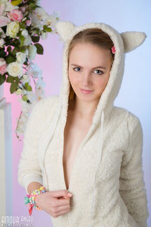Lovely minx takes off pajamas and panties to show photographer her sweet body
