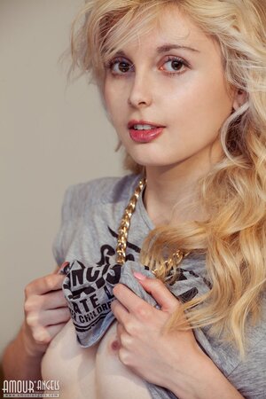 After bathroom naughty blonde doesn't mind stripping naked for a photographer