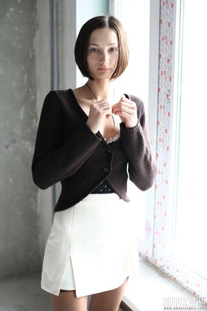 Girl poses in dress and then takes it off opening her shaved snatch on windowsill