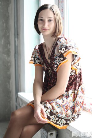 Girl poses in dress and then takes it off opening her shaved snatch on windowsill