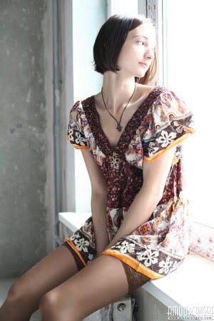 Girl poses in dress and then takes it off opening her shaved snatch on windowsill