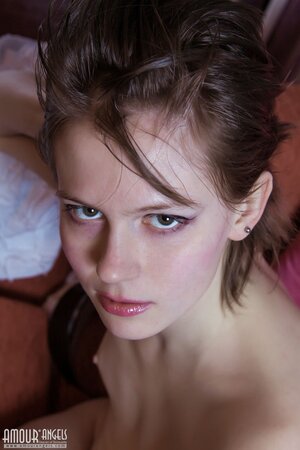 Rebellious cutie with small tits provocatively undresses in the living room