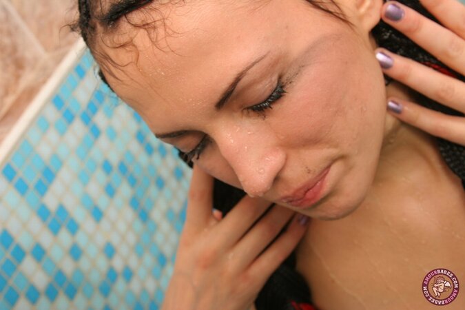 Twin-tailed brunette seductively poses naked while relaxing in the bathroom