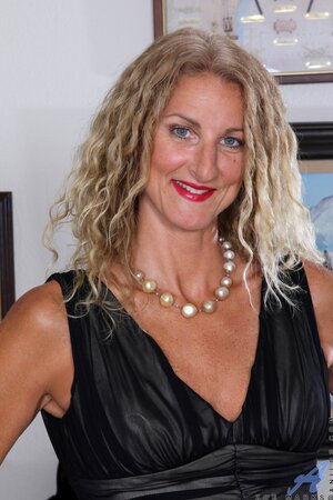 Female in black dress and red high heels exposes her body with tan lines