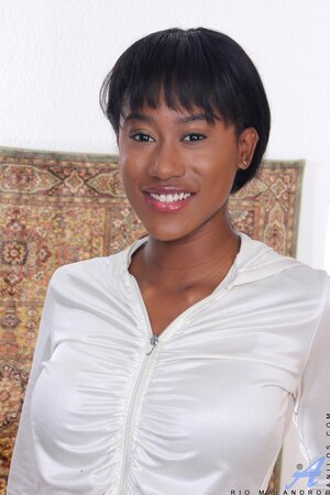 Ebony female in a black jacket with zipper spreads legs and fingers her cherry