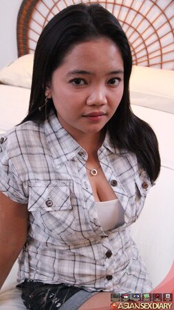 Asian chick in a checkered shirt sucks and gives hairy cunt to boy for drilling