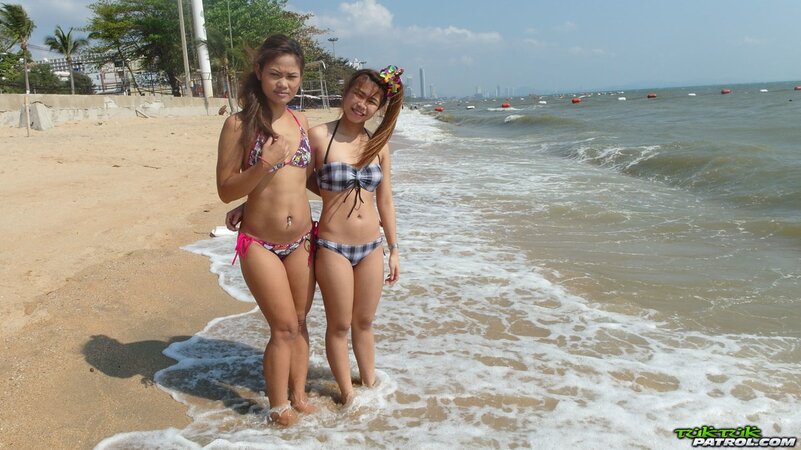 Thai babes rest on a beach and pose in tight bikini flashing innie navels