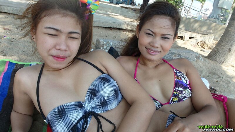 Thai babes rest on a beach and pose in tight bikini flashing innie navels