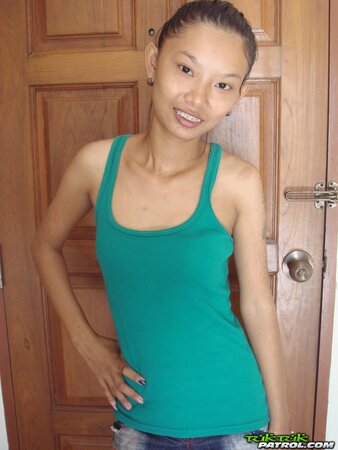Skinny young Asian woman satisfies her sexual cravings getting naked