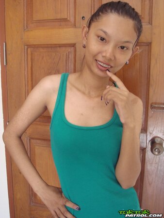 Skinny young Asian woman satisfies her sexual cravings getting naked
