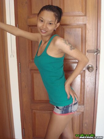 Skinny young Asian woman satisfies her sexual cravings getting naked