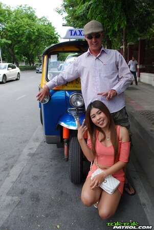 Joyful Thai minx poses near white fellow and his impressive auto rickshaw