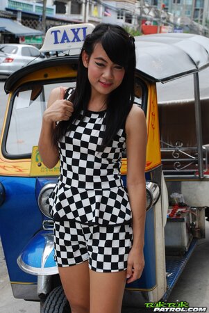 Inviting Thai model in a checkered dress gets into the Tuk Tuk Taxi