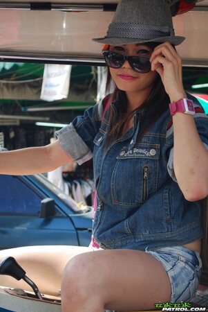 Joyful exotic teen agrees to pose with mature guy near auto rickshaw