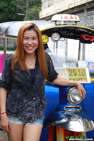 Clothed Thai girl with a cute face and red hair can brag about wonderful legs