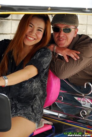 Clothed Thai girl with a cute face and red hair can brag about wonderful legs