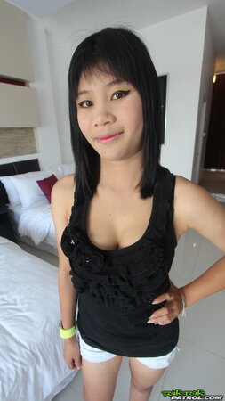 Young Eastern woman with a wide smile exposes small tits and shaved vagina