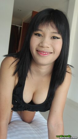 Young Eastern woman with a wide smile exposes small tits and shaved vagina