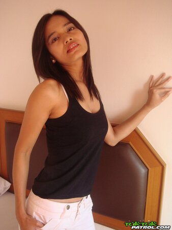 Young woman with oriental features get rid of outfit and fingers own pudenda