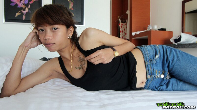 Eastern girl looks into the camera so alluring while taking her clothes down