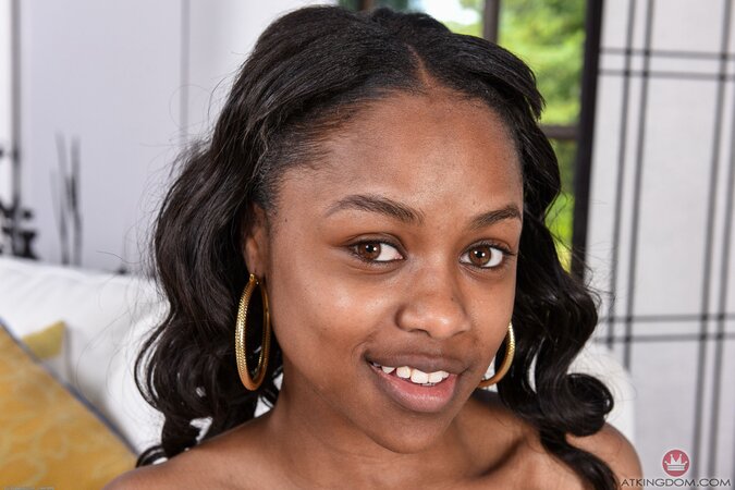 Ebony love with full lips takes her snatch to light in front of a big window