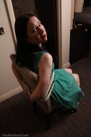Pervert catches woman in green polka dot dress and ties her to chair