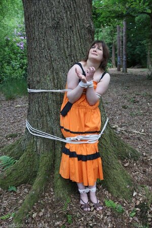 Helpless housewife is captured by lover and tied up to tree in public park